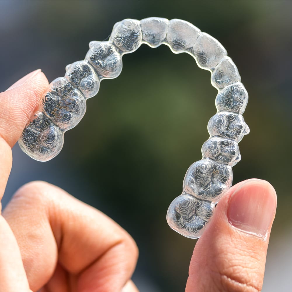 An extreme close up of an Invisalign clear aligner.