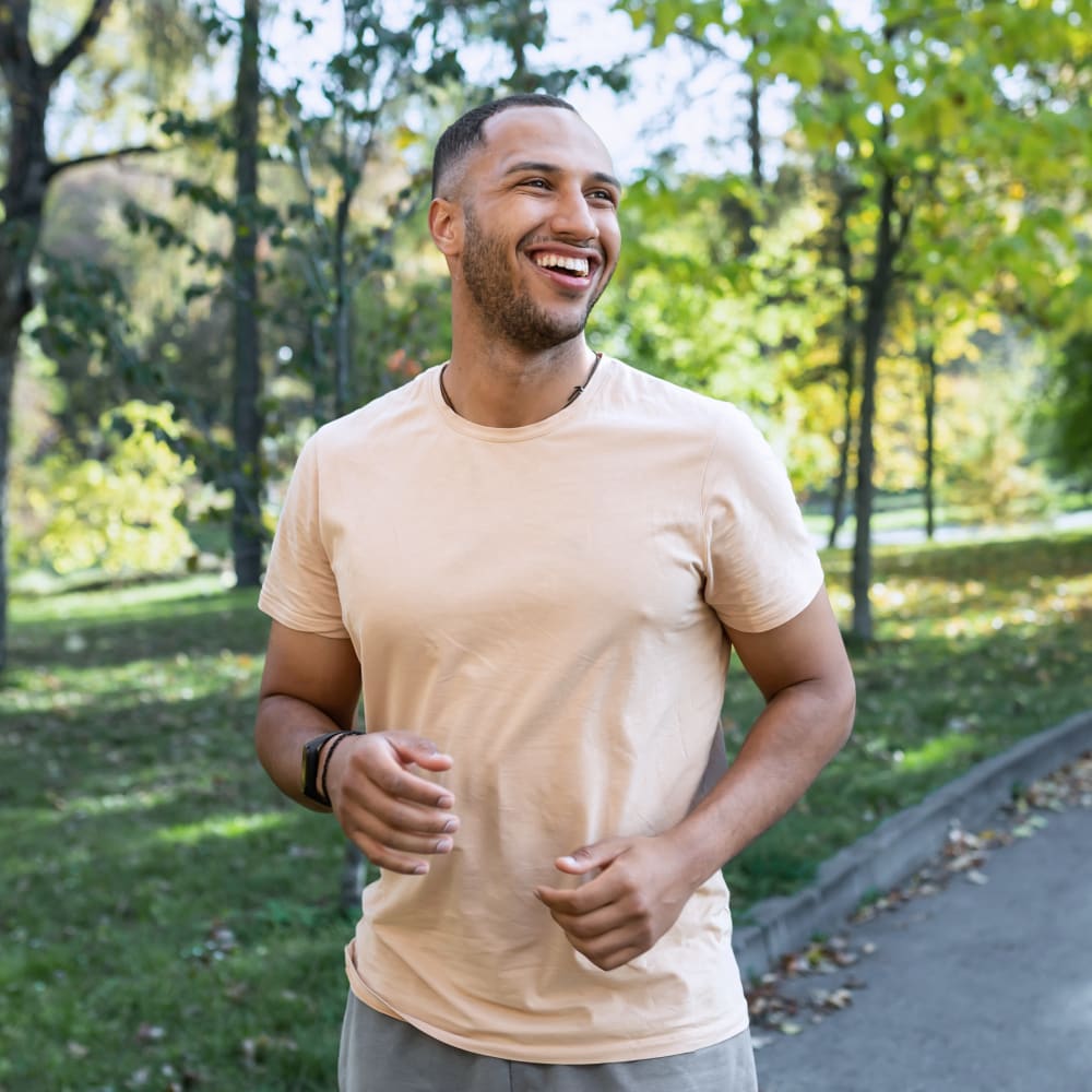 A man is out for a stroll among the trees.